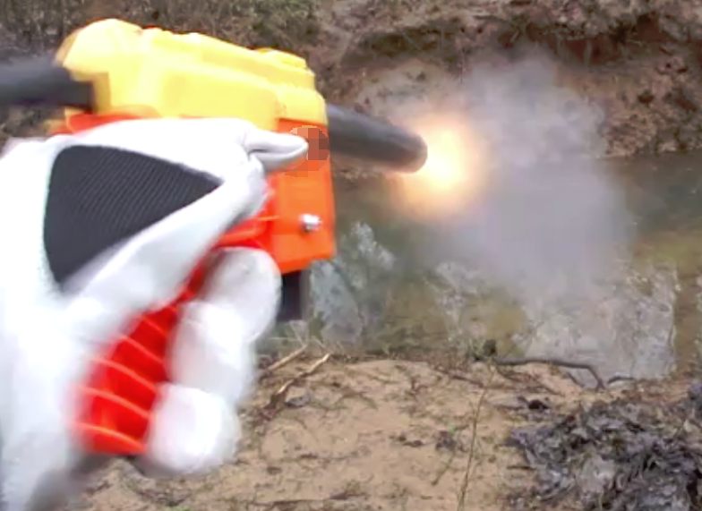 Still frame of the dart blaster being fired in a controlled environment